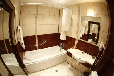 a bathroom with a tub and a sink at Hi Boutique Hotel in Varna City