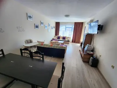 a living room with a couch and a table at Villa Bonita Apartment in Sunny Beach