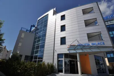 a white building with a sign on it at Regata Palace Hotel in Sunny Beach