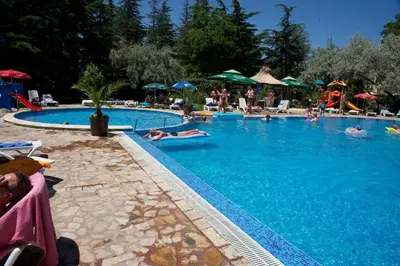 a large swimming pool with people laying in it at Dunav Hotel in Sunny Beach