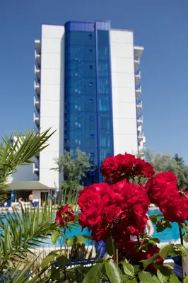 a building with red flowers in front of a building at Dunav Hotel in Sunny Beach