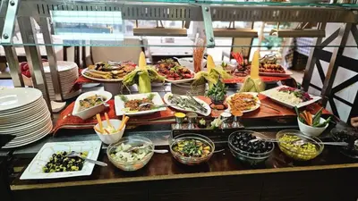 a buffet with many plates of food on a table at Tropics Hotel - Ultra All Inclusive in Sveti Vlas