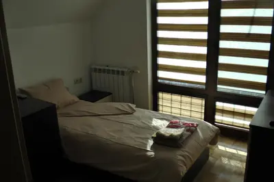 a bedroom with a bed with two towels on it at TOP CENTER , MODERN AND QUIET APARTMENT in Burgas City