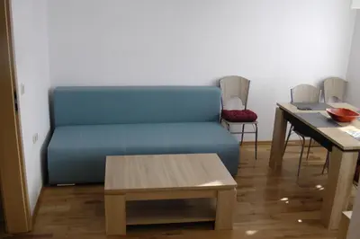 a living room with a blue couch and a table at TOP CENTER , MODERN AND QUIET APARTMENT in Burgas City