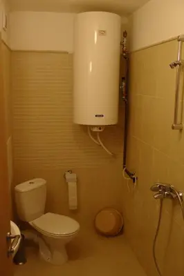 a small bathroom with a toilet and a shower at TOP CENTER , MODERN AND QUIET APARTMENT in Burgas City