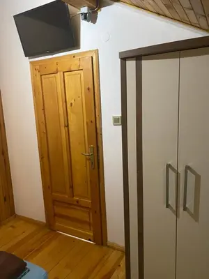 a room with a door and a television on the wall at Villas Sozopol in Sozopol