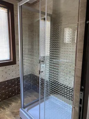 a shower with a glass door in a bathroom at Villas Sozopol in Sozopol