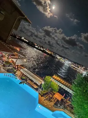 a pool with a view of the water at night at Villas Sozopol in Sozopol
