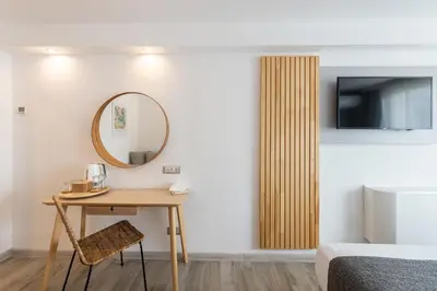 a room with a table and a mirror and a bed at iHotel Sunny Beach in Sunny Beach