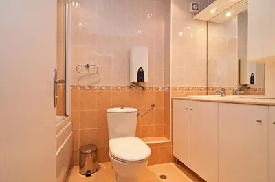 a bathroom with a toilet and a sink and a shower at Sun City I Apartments in Sunny Beach