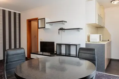 a dining room with a table and chairs at Семеен Хотел Опера in Burgas City