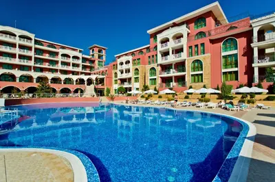 a large swimming pool in front of some apartment buildings at Saint George Palace Hotel All-inclusive in Sveti Vlas