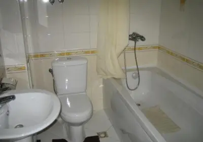 a bathroom with a toilet and a sink and a tub at Sozopol Dreams Apartments in Sozopol