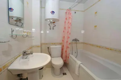 a bathroom with a sink and a toilet and a tub at Sozopol Dreams Apartments in Sozopol