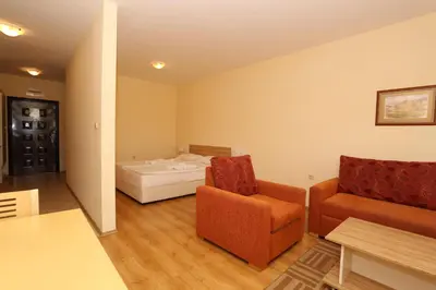 a room with a bed and a couch and a chair at Galeria Holiday Apartments in Obzor