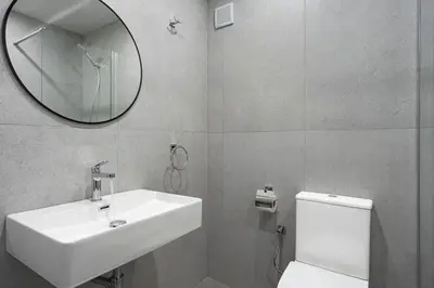 a bathroom with a sink and a mirror and a toilet at Zefir Hotel in Sunny Beach
