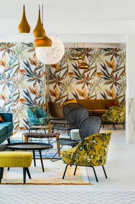 a room with chairs and tables and a wallpaper at Zefir Hotel in Sunny Beach
