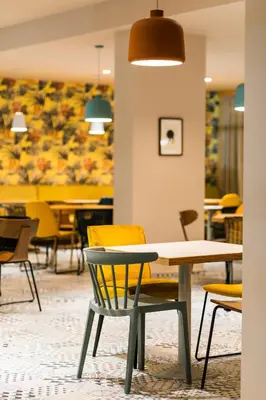 a dining room with chairs and a table and a painting at Zefir Hotel in Sunny Beach