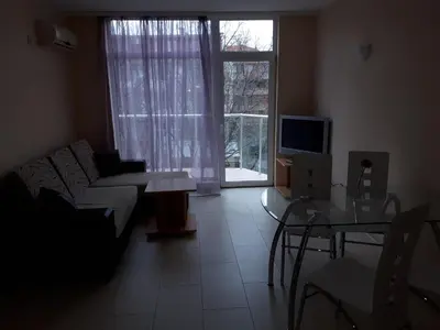 a living room with a couch and a table and a window at Apart Hotel Ravda in Ravda