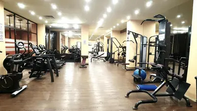 a gym with several treadmills and machines in a room at Barcelo SeaView Apartment in Sunny Beach