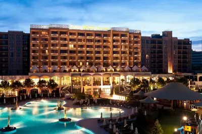 a hotel with a large pool in front of a building at Barcelo SeaView Apartment in Sunny Beach