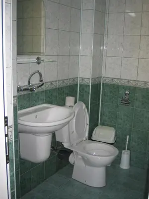 a bathroom with a toilet and a sink at КЪЩА