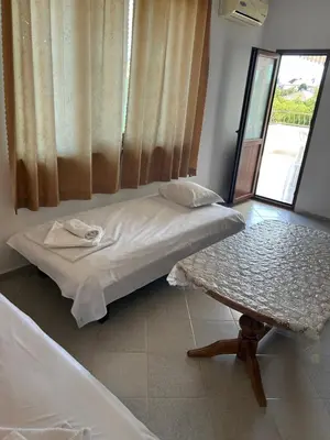 a bed in a room with a table and a window at КЪЩА