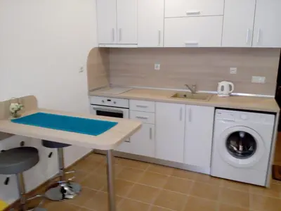 a kitchen with a sink and a washing machine at Studio Zlatina in Pomorie