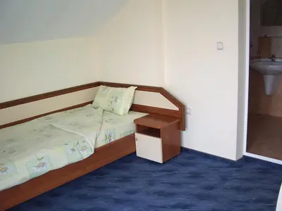 a small bedroom with a bed and a sink at Vanessa Family Hotel in Ravda