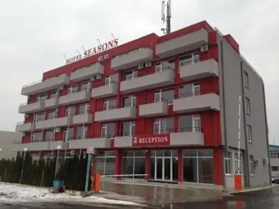 a red and gray hotel with a red and white building at Hotel Seasons 2 in Sunny Beach