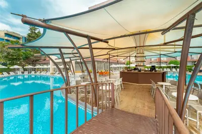 a balcony with a pool and tables and chairs at MPM Astoria Hotel - Ultra All Inclusive in Sunny Beach