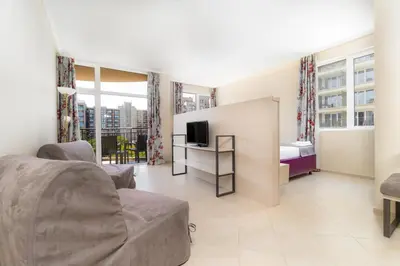 a living room with a couch and a tv at MPM Astoria Hotel - Ultra All Inclusive in Sunny Beach