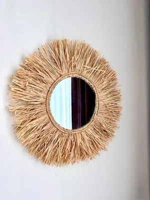 a round mirror on a white wall with at Sineva Del Sol Apartments in Sveti Vlas