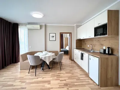 a kitchen and dining room with a table and chairs at Sineva Del Sol Apartments in Sveti Vlas