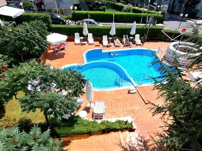 an overhead view of a swimming pool with chairs and umbrellas at Sineva Del Sol Apartments in Sveti Vlas