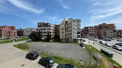 a parking lot with parked cars in a city at Evi Apartments 2 in Pomorie