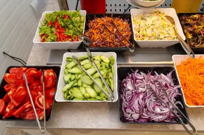 a refrigerator filled with different types of vegetables in trays at MPM Hotel Orel - Ultra All Inclusive in Sunny Beach
