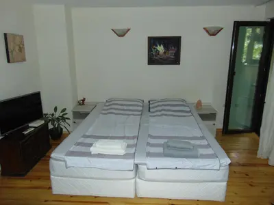 a bedroom with a bed and a flat screen tv at Burgas Central Aleksandrovska in Burgas City