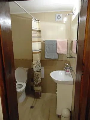 a small bathroom with a toilet and a sink at Burgas Central Aleksandrovska in Burgas City
