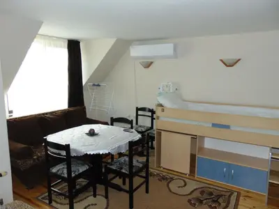a room with a bed and a table and chairs at Burgas Central Aleksandrovska in Burgas City
