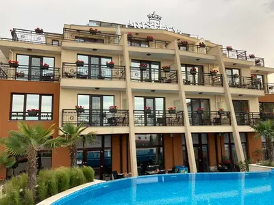 a hotel with a swimming pool in front of it at Cristiani Hotel Sozopol in Sozopol