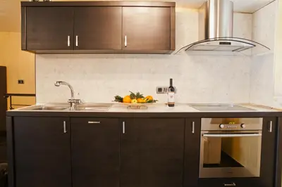 a kitchen with a sink and a counter top at Efbet Hotel in Varna City