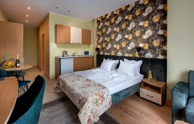 a hotel room with a bed and a kitchen at Hotel Avenue in Sunny Beach