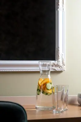a glass vase with fruit in it on a table at Hotel Avenue in Sunny Beach