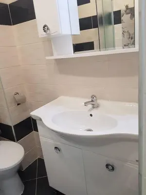 a bathroom with a white sink and a toilet at Guest House Evtimov in Primorsko