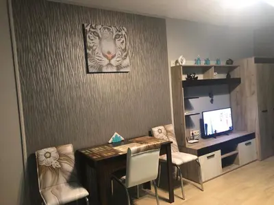 a dining room with a table and chairs and a television at Studio Eva 31 in Pomorie