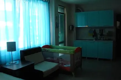 a living room with a couch and a kitchen at Studio Eva 31 in Pomorie