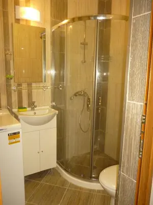 a bathroom with a shower and a sink and a toilet at Studio Eva 31 in Pomorie