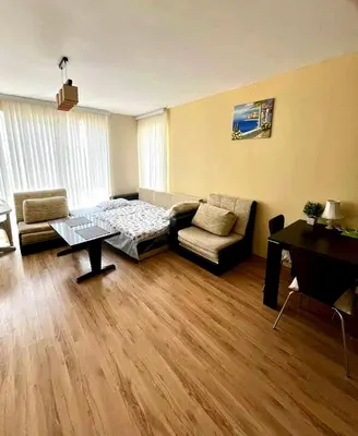 a living room with a couch and a table at Sirena Appartment in Sveti Vlas