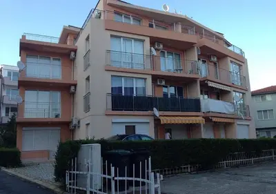 a tall building with a fence in front of it at Sirena Appartment in Sveti Vlas